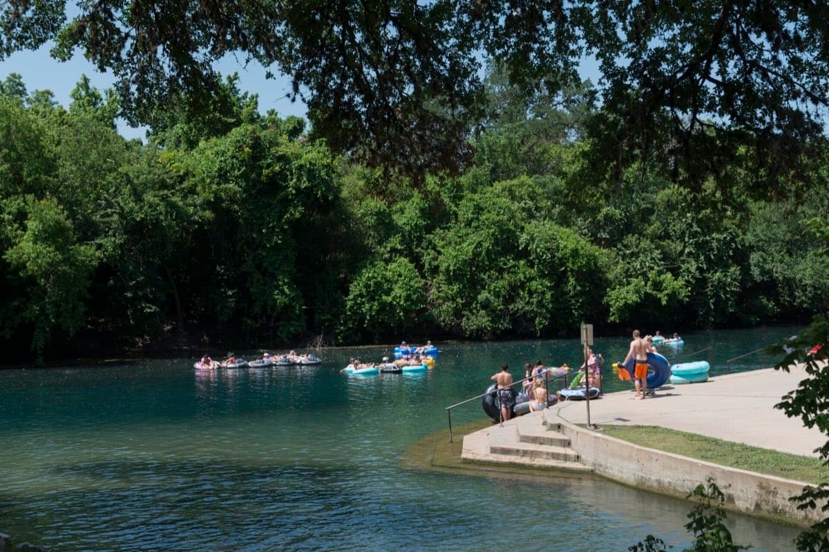 Tubers on the Comal River in New Braunfels TX during river season — peak porta potty rental demand